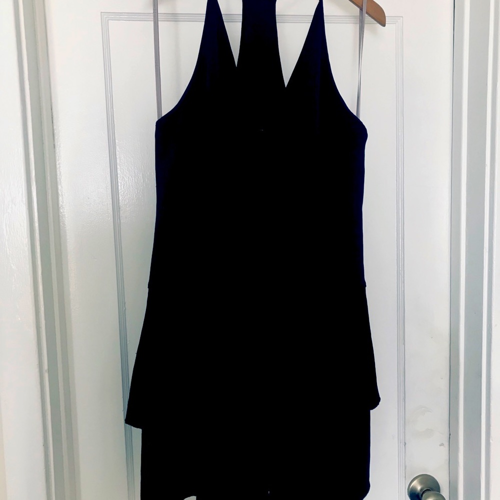 Flirty black cocktail dress a mix of satin and crepe razorback style.